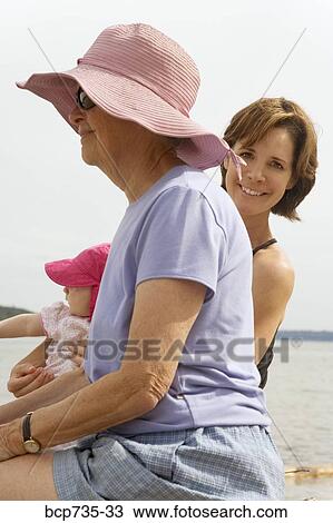 Grandmother and mother with baby at beach View Large Photo Image Stock Image - Grandmother and mother with baby at beach. Fotosearch