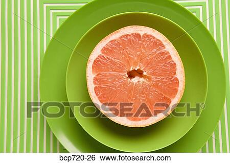 Grapefruit on green plate View Large Photo Image Stock Photograph - Grapefruit on green plate. Fotosearch