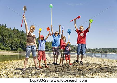 Group of children cheering at beach View Large Photo Image Stock Image - Group of children cheering at beach. Fotosearch