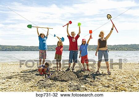 Group of children cheering at beach View Large Photo Image Stock Image - Group of children cheering at beach. Fotosearch