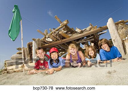Stock Photo - Group of children in beach fort. Fotosearch