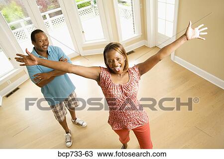 Stock Image - Happy African couple in new house. Fotosearch