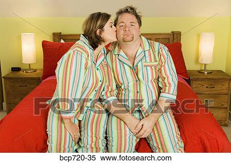 Kissing couple wearing matching pajamas View Large Photo Image Stock Photography - Kissing couple wearing matching pajamas. Fotosearch