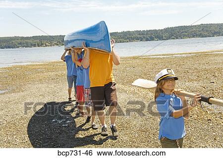 Male camp counselor and children carrying canoe View Large Photo Image Stock Photograph - Male camp counselor and children carrying canoe. Fotosearch