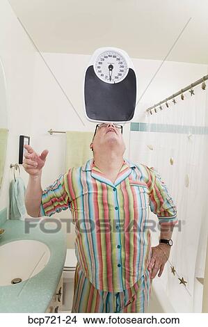 Man balancing a scale on his nose View Large Photo Image Picture - Man balancing a scale on his nose. Fotosearch