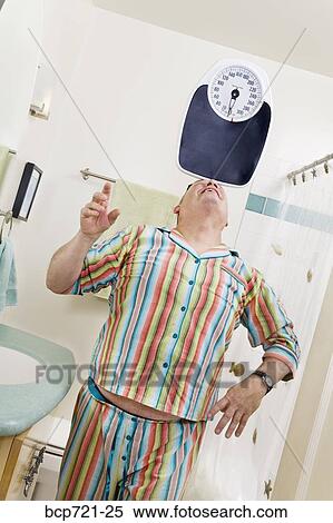 Man balancing a scale on his nose View Large Photo Image Stock Photography - Man balancing a scale on his nose. Fotosearch