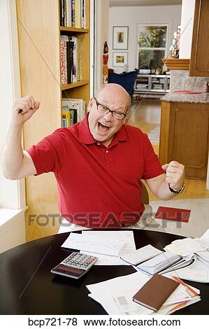 Stock Photo - Man celebrating after paying bills. Fotosearch