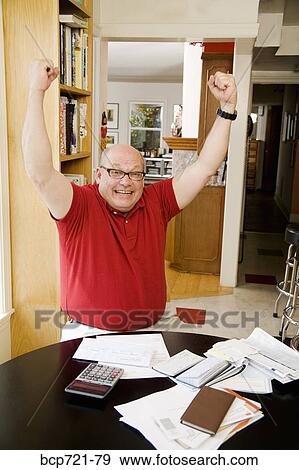 Stock Photo - Man celebrating after paying bills. Fotosearch