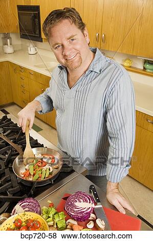 Man cooking View Large Photo Image Stock Photo - Man cooking. Fotosearch