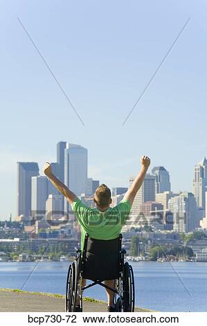 Man in wheelchair looking at city skyline View Large Photo Image Stock Image - Man in wheelchair looking at city skyline. Fotosearch
