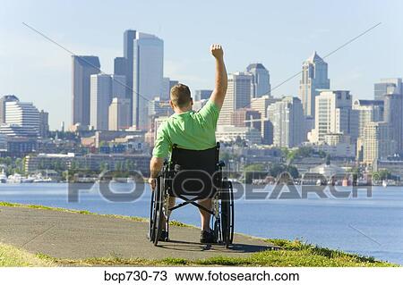 Man in wheelchair looking at city skyline View Large Photo Image Stock Image - Man in wheelchair looking at city skyline. Fotosearch