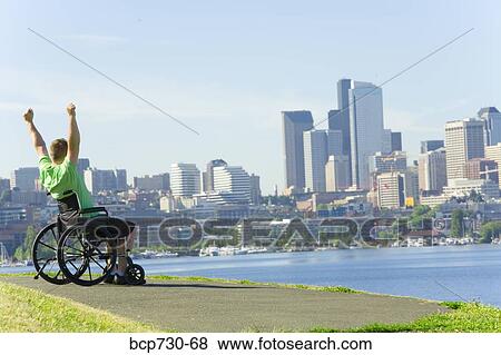 Man in wheelchair looking at city skyline View Large Photo Image Stock Photo - Man in wheelchair looking at city skyline. Fotosearch