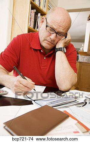 Man paying bills View Large Photo Image Picture - Man paying bills. Fotosearch