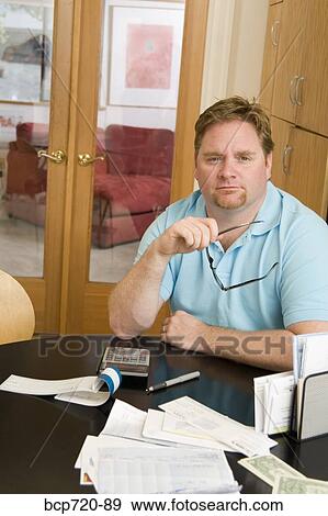 Man paying bills View Large Photo Image Stock Photo - Man paying bills. Fotosearch