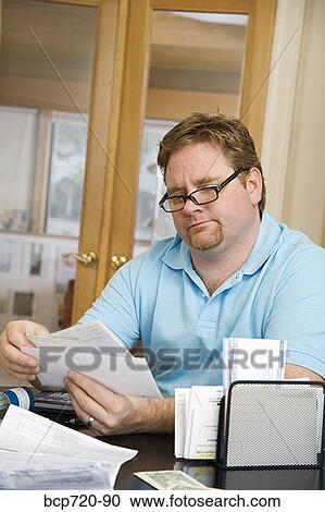 Stock Image - Man reading mail. Fotosearch