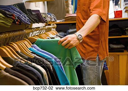 Man shopping in clothing store View Large Photo Image Stock Image - Man shopping in clothing store. Fotosearch