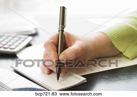 Stock Image - Man writing a check. Fotosearch