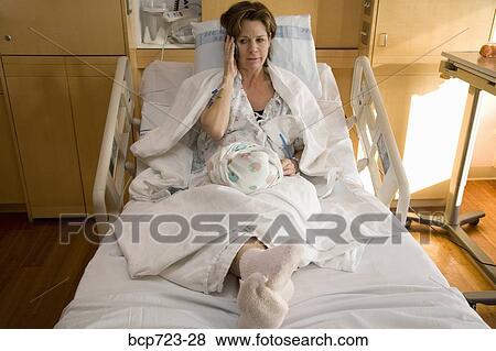 Mother holding newborn infant in hospital View Large Photo Image Stock Photo - Mother holding newborn infant in hospital. Fotosearch