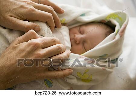Mother swaddling newborn infant View Large Photo Image Stock Photograph - Mother swaddling newborn infant. Fotosearch