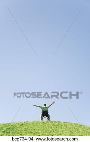 Person in wheelchair on top of hill View Large Photo Image Picture - Person in wheelchair on top of hill. Fotosearch