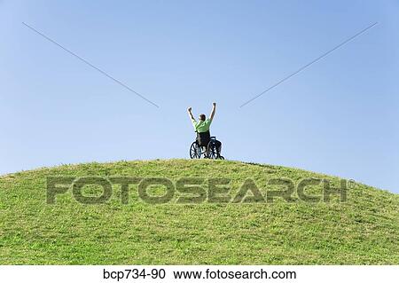 Person in wheelchair on top of hill View Large Photo Image Stock Image - Person in wheelchair on top of hill. Fotosearch