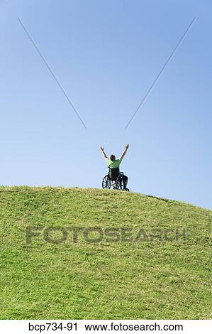 Person in wheelchair on top of hill View Large Photo Image Stock Image - Person in wheelchair on top of hill. Fotosearch