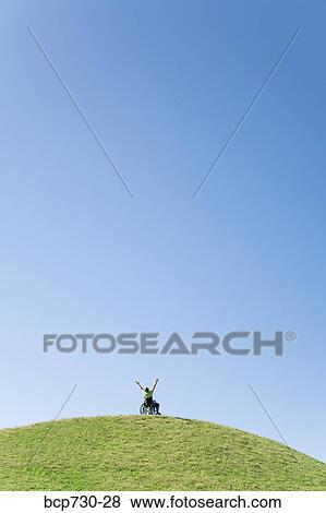 Person in wheelchair on top of hill View Large Photo Image Stock Photo - Person in wheelchair on top of hill. Fotosearch