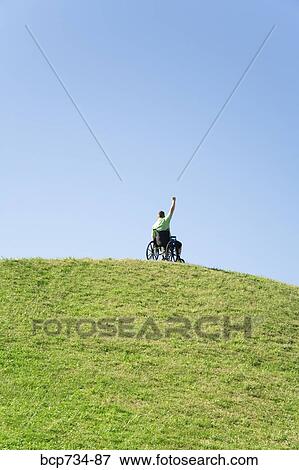Person in wheelchair on top of hill View Large Photo Image Stock Photo - Person in wheelchair on top of hill. Fotosearch