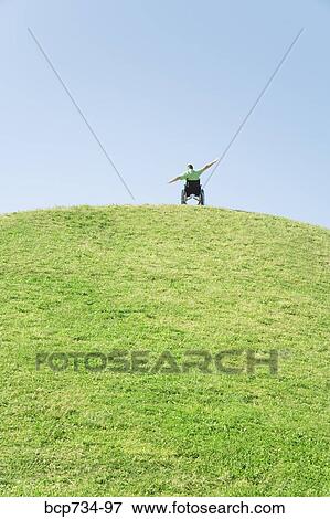 Person in wheelchair on top of hill View Large Photo Image Stock Photo - Person in wheelchair on top of hill. Fotosearch