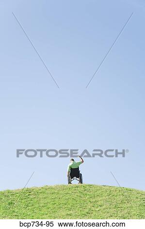 Person in wheelchair on top of hill View Large Photo Image Stock Photography - Person in wheelchair on top of hill. Fotosearch