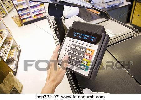 Person using debit card transaction machine View Large Photo Image Stock Photo - Person using debit card transaction machine. Fotosearch