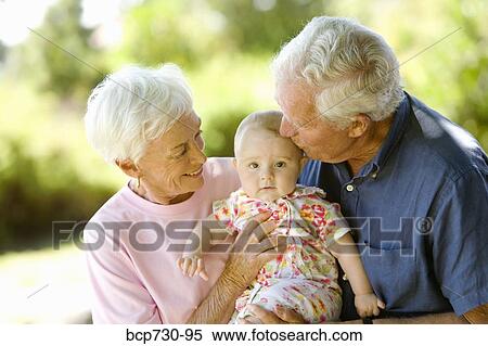 Senior couple holding baby View Large Photo Image Stock Photography - Senior couple holding baby. Fotosearch