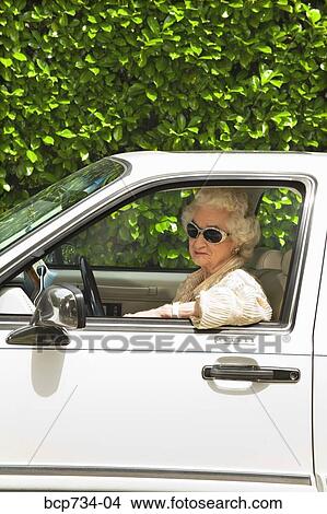 Senior woman driving car View Large Photo Image Picture - Senior woman driving car. Fotosearch
