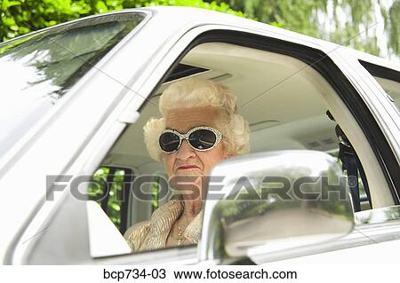 Senior woman driving car View Large Photo Image Stock Image - Senior woman driving car. Fotosearch