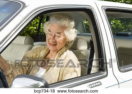 Senior woman driving car View Large Photo Image Stock Photo - Senior woman driving car. Fotosearch