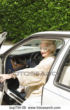 Senior woman getting into car View Large Photo Image Stock Photograph - Senior woman getting into car. Fotosearch