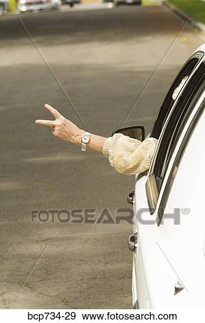 Stock Photo - Senior woman’s arm sticking out of car. Fotosearch