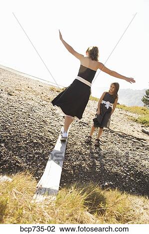 Stock Image - Sisters in party dresses outdoors. Fotosearch