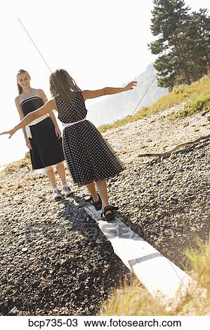 Sisters in party dresses outdoors View Large Photo Image Stock Image - Sisters in party dresses outdoors. Fotosearch