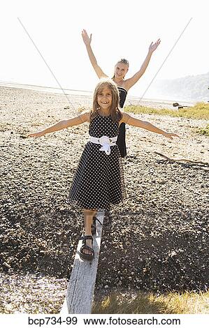 Sisters in party dresses outdoors View Large Photo Image Stock Photo - Sisters in party dresses outdoors. Fotosearch
