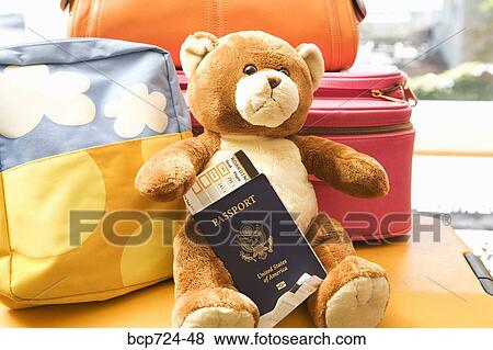 Teddy bear holding passport View Large Photo Image Stock Photo - Teddy bear holding passport. Fotosearch