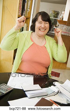 Woman celebrating after paying bills View Large Photo Image Stock Photo - Woman celebrating after paying bills. Fotosearch