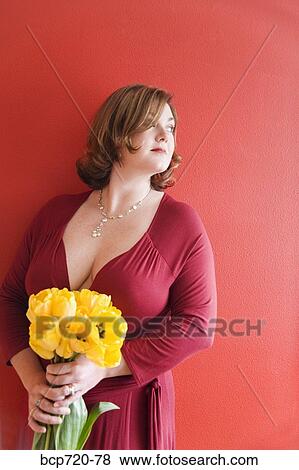Woman holding a bouquet of flowers View Large Photo Image Stock Photo - Woman holding a bouquet of flowers. Fotosearch