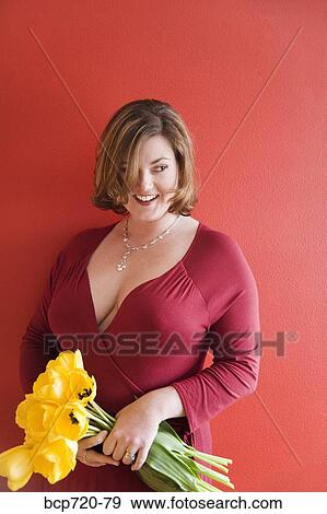 Woman holding a bouquet of flowers View Large Photo Image Stock Photo - Woman holding a bouquet of flowers. Fotosearch