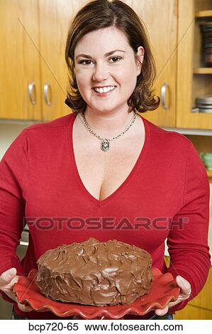 Woman holding frosted cake View Large Photo Image Stock Photography - Woman holding frosted cake. Fotosearch
