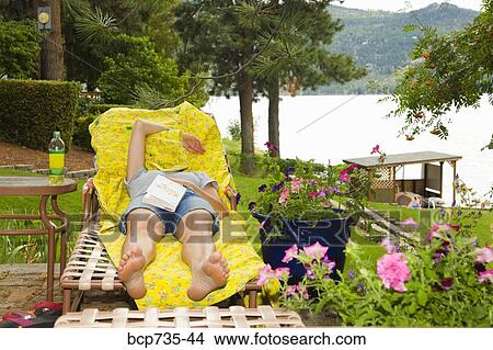 Woman in lounge chair with blanket over face View Large Photo Image Picture - Woman in lounge chair with blanket over face. Fotosearch