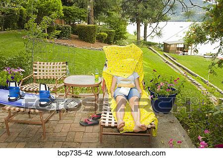 Woman in lounge chair with blanket over face View Large Photo Image Stock Image - Woman in lounge chair with blanket over face. Fotosearch