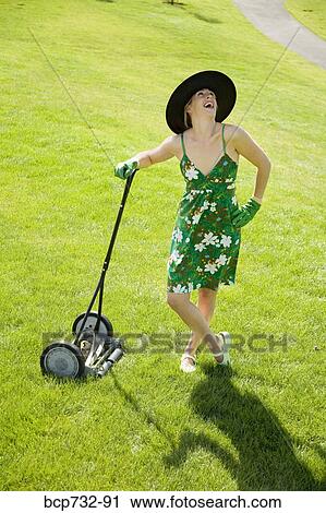 Woman leaning on push lawn mower View Large Photo Image Stock Image - Woman leaning on push lawn mower. Fotosearch