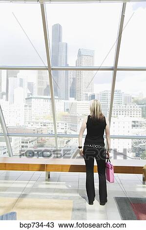Stock Image - Woman looking out window. Fotosearch