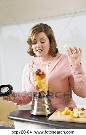 Woman making a smoothie View Large Photo Image Picture - Woman making a smoothie. Fotosearch